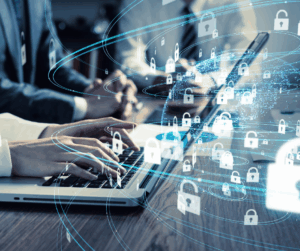 Business professionals working on laptops with an overlay of digital padlocks and global network graphics, representing secure authentication in a connected environment.
