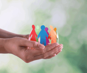 Hands gently holding a circle of multicolored paper cut-out people, symbolizing inclusivity, accessibility, and equitable identity solutions