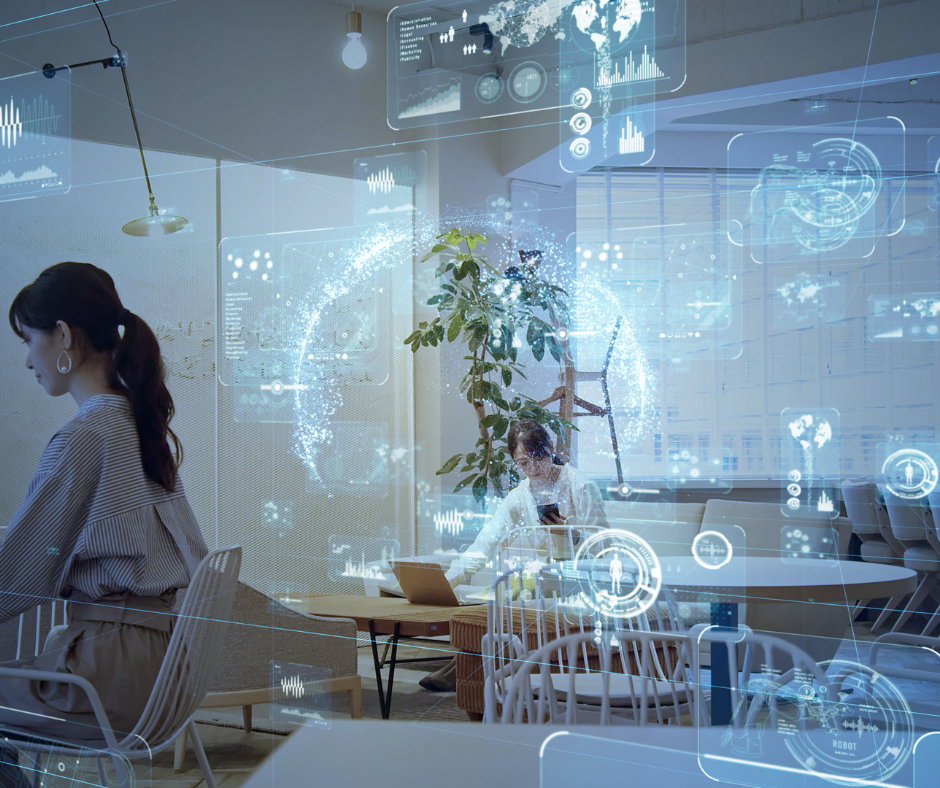 Employees working in a smart office with holographic data interfaces representing real-time access, monitoring, and identity governance