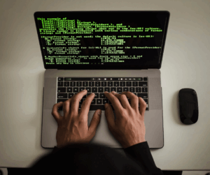 Person typing on laptop with digital security and cloud access icons, illustrating identity management and secure access.
